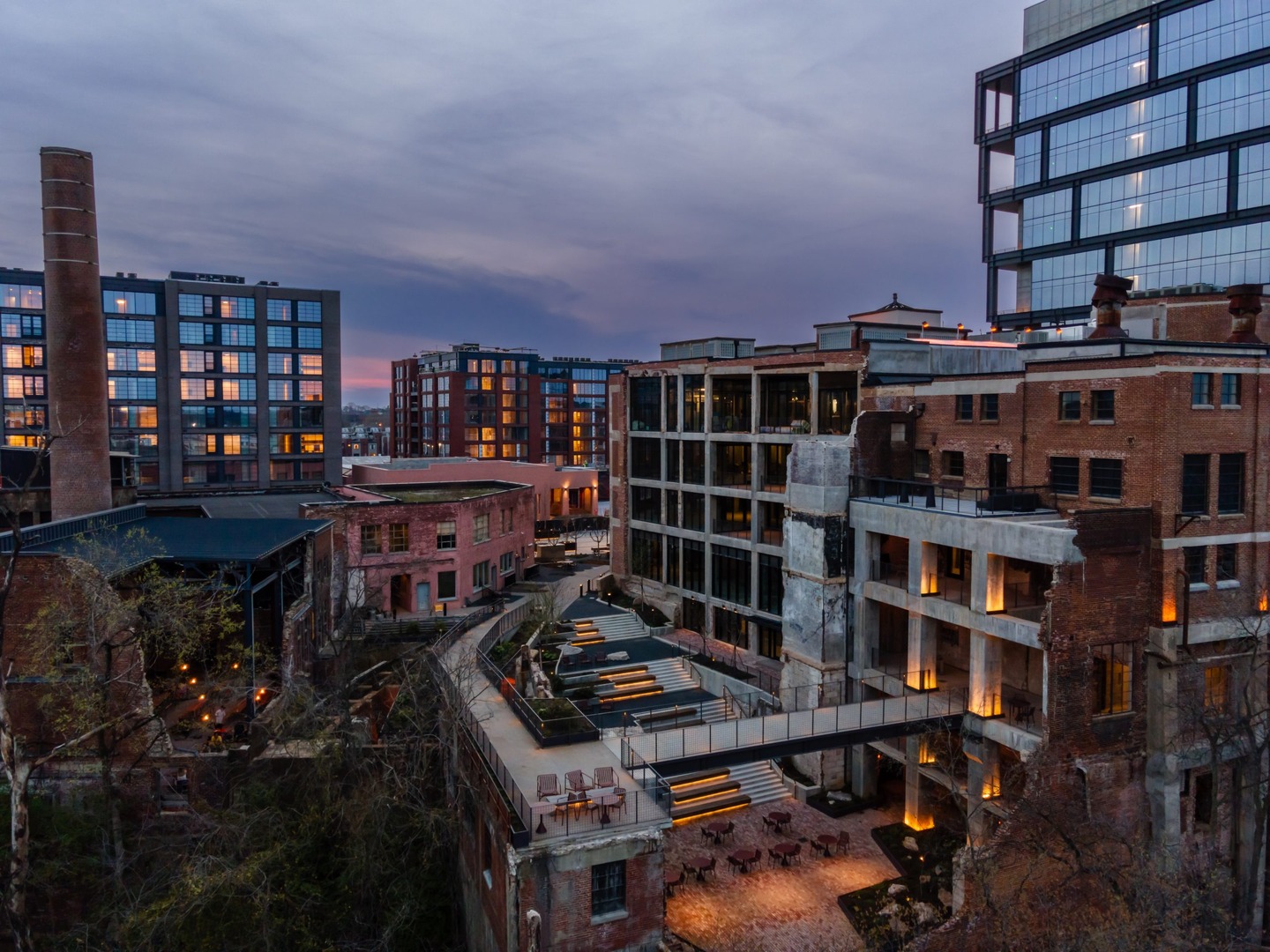 Industrial & residential buildings, a smokestack, & a courtyard near Neuhoff Residences